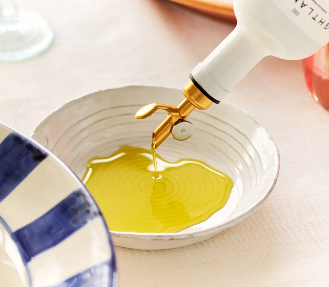 Olive oil poured into a blue and white bowl
